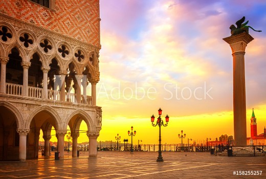 Picture of Famouse Doge palace column with winged lion and San Marco square at sunrise Venice Italy retro toned